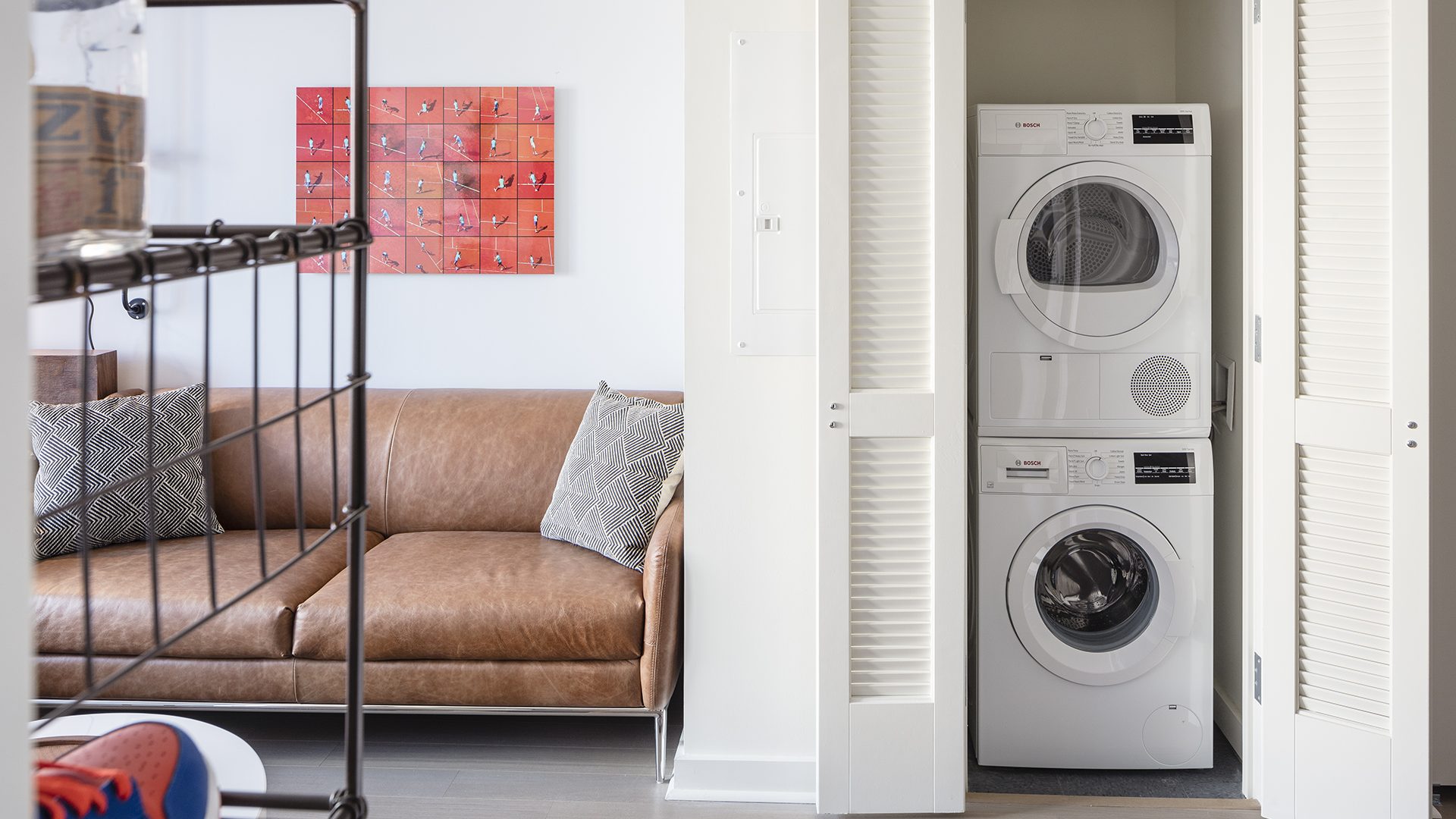 An image inside of a studio apartment featuring in-unit washer and dryer